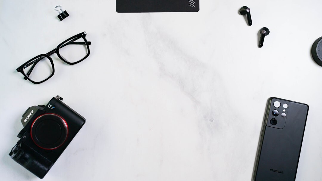 Flat lay of leather accessories, watch and perfume bottle on marble