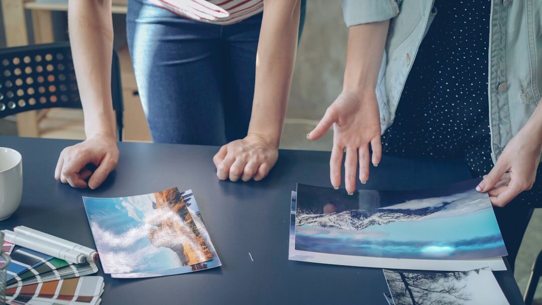 Editors reviewing magazine layouts on a large table