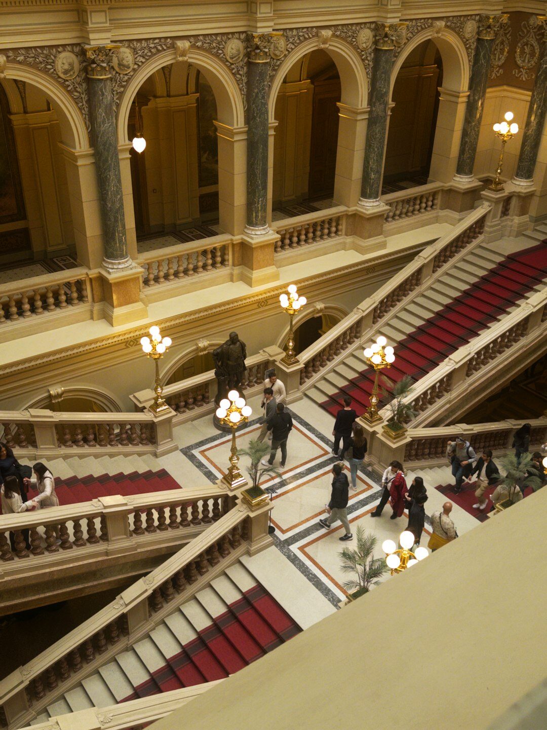Grand theater staircase with guests descending in evening attire