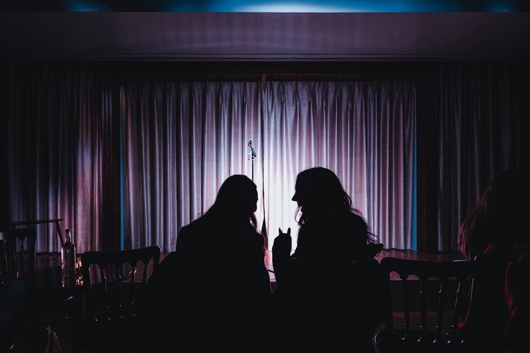 Elegant gala reception with guests silhouetted against warm light