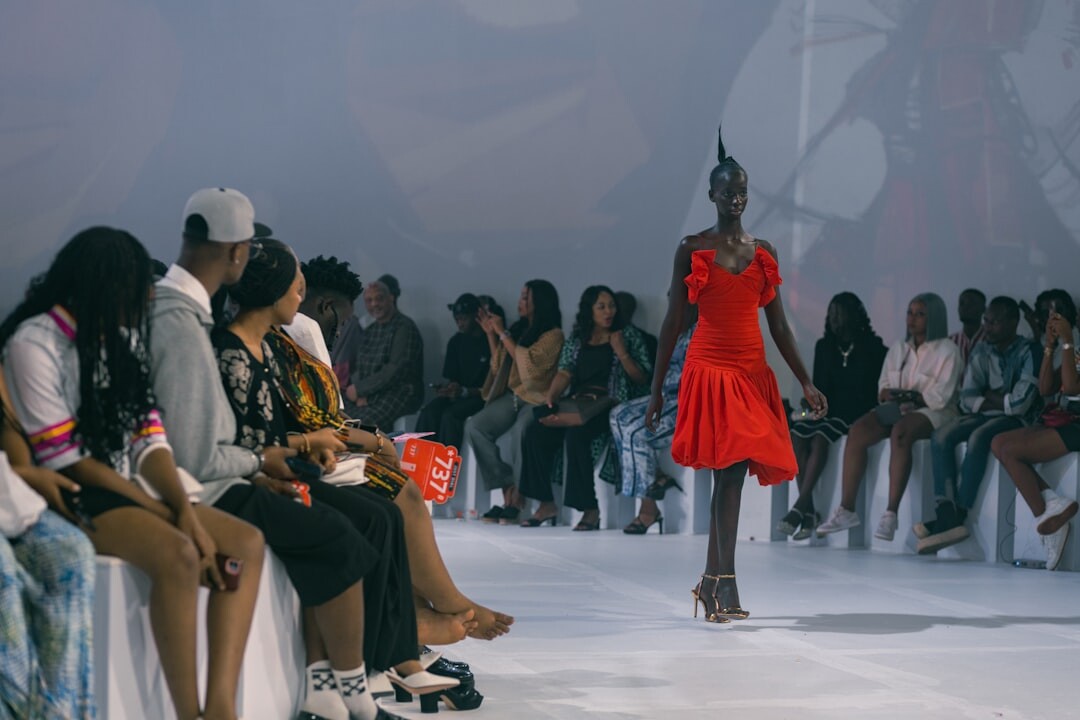 Fashion runway show with models walking under spotlights